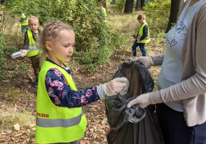Na zdjęciu widać dzieci zbierające śmieci w Parku 3 Maja podczas akcji Sprzątanie świata